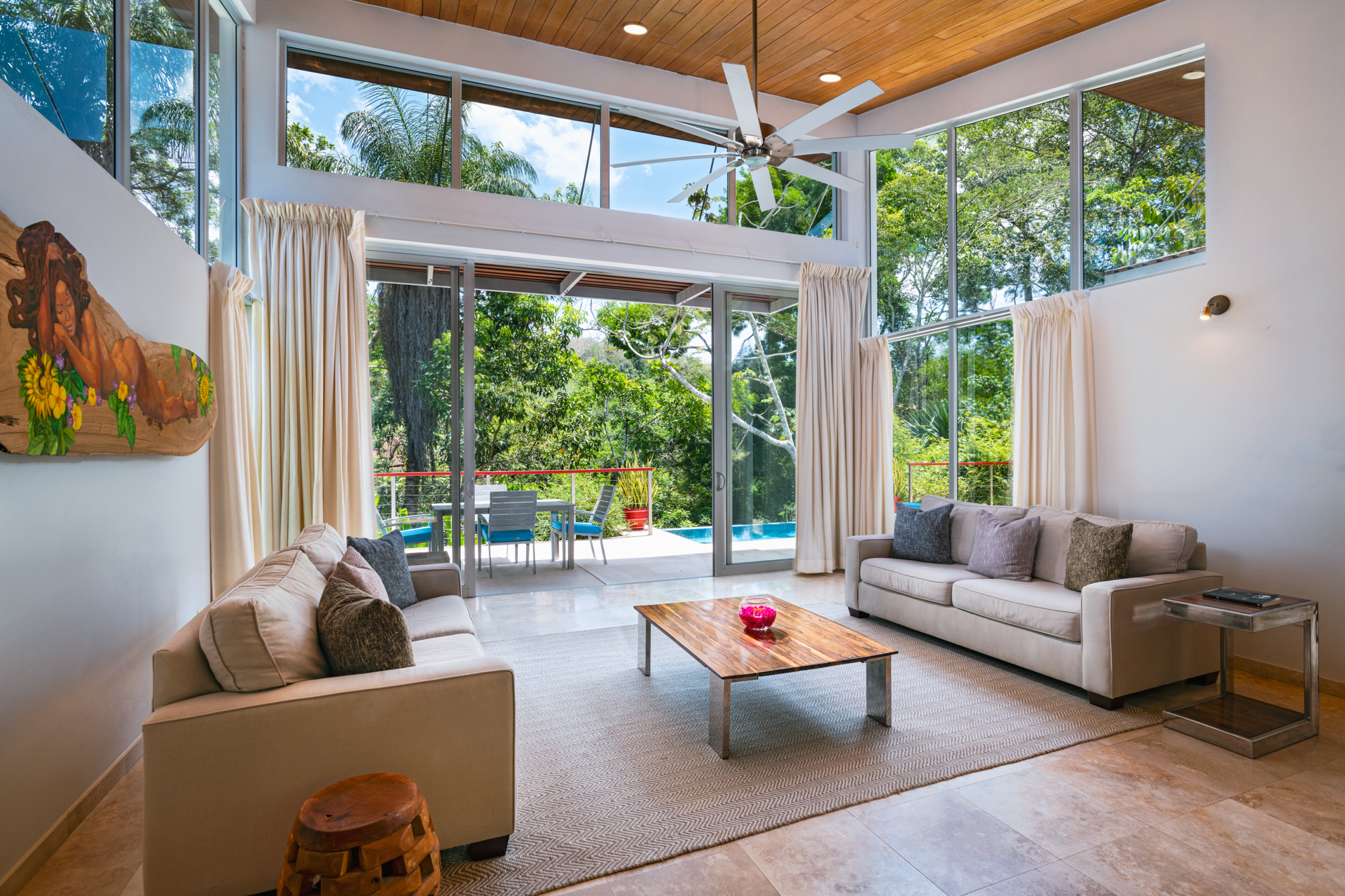 Elegant living room inside the Ix Chel Villa at The Lodge at Chaa Creek in Belize, featuring open-concept design with rainforest views.